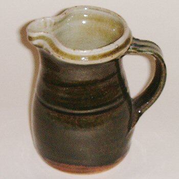 Pint Stoneware jug with green glaze.
