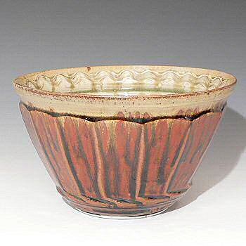 Large deep facetted bowl with scraped decoratio inside.