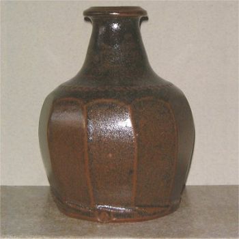 Facetted stoneware bottle.