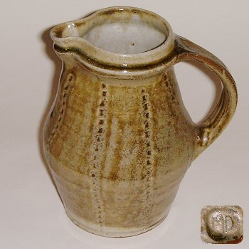Stoneware jug with incised decoration.