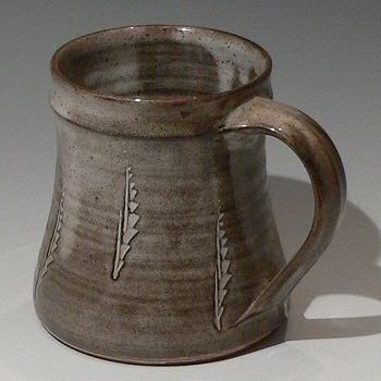 Stoneware mug with incised decoration.