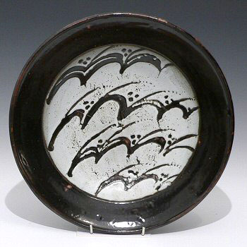 Stoneware plate with waves decoration.
