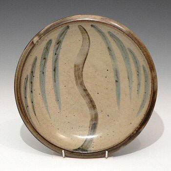 Stoneware plate with willow tree decoration.