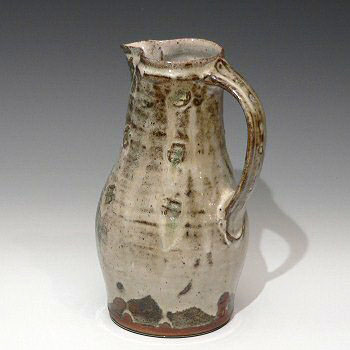 Stoneware jug with embossed decoration.
