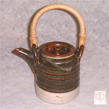 Small temmoku glazed tea pot with cane handle