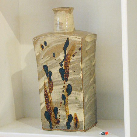 Moulded bottle, white slip with iron and manganese decoration