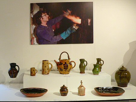 Image of Doug firing his kiln, exhibition pots in the foreground