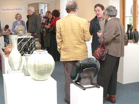 Peter Swanson in discussion with a couple at the preview