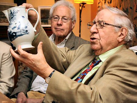 Henry evaluating a blue and white jug