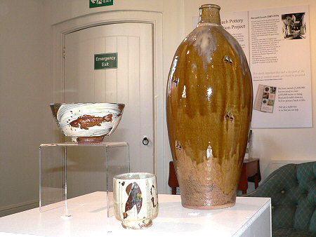 Tall bottle with manganese and ash glaze, akeme glazed bowl with fish decoration, hakeme glazed yunomi with iron decoration