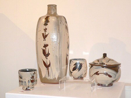 akeme glazed pots with painted iron decoration - tall squared bottle vase, lidded jar and a couple of yunomis
