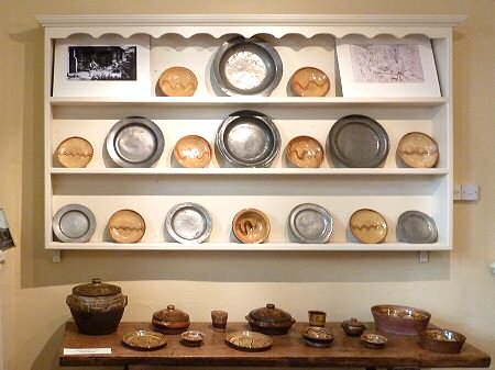 On the shelves, dishes from the late 1920s alongside pewter plates