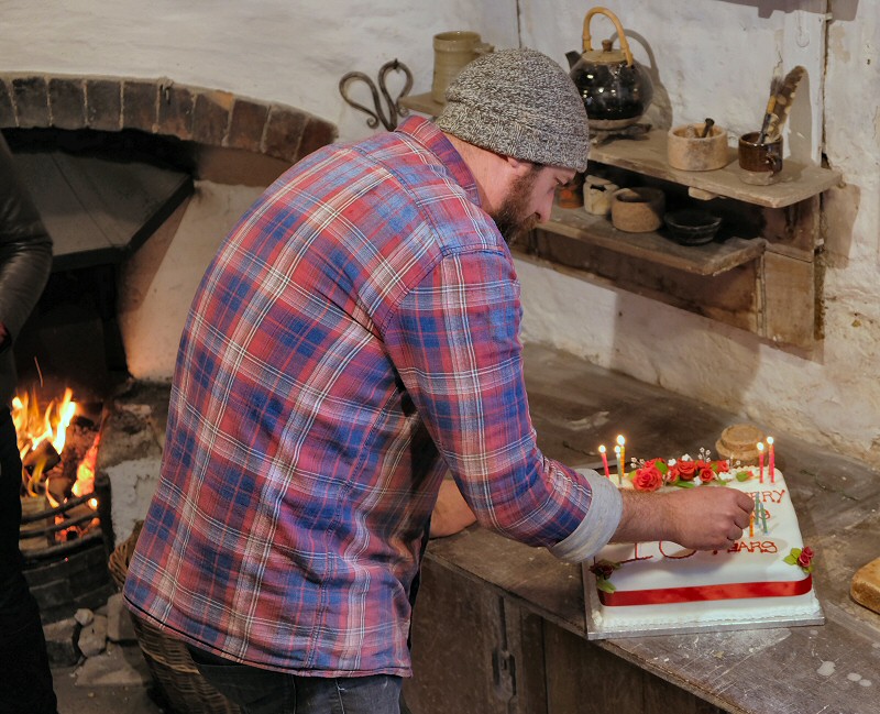 Lead Potter Roelof Uys lighting  the candles on the celebratory cake