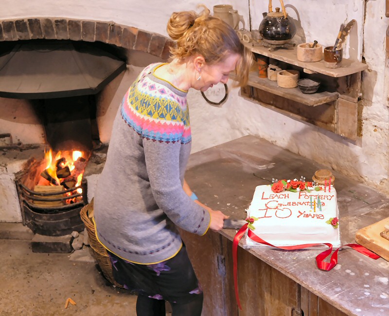 Director Libby Buckley cutting  the celebratory cake