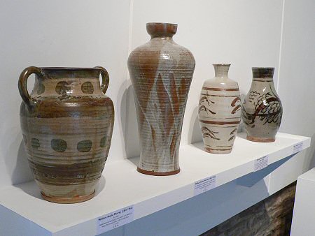 Bernard Leach vase with fish decoration surrounded by William Staite-Murray pots