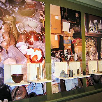 Display cases with images of Bills pots at home behind