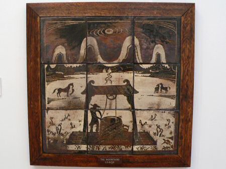 Bernard Leach tiled plaque with well head and mountains beyond