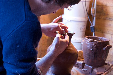 Matt Grimmitt adding a pouring spout to a jug while still on wheel head