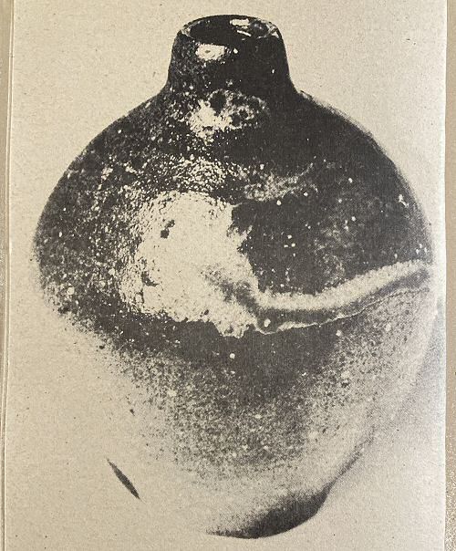 Unglazed 5 inch bottle, ashing has run down side, flecking from feldspar particles