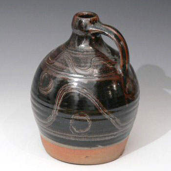 Stoneware cider flagon with wavy decoration.