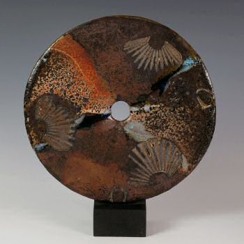 Stoneware disc on slate plinth