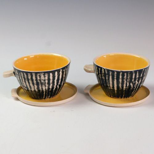 Eric Leaper - Pair of yellow handled bowls with saucers