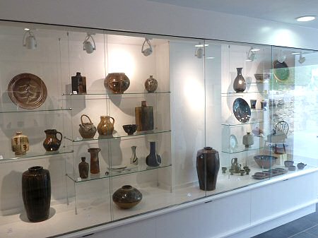 The new display case in the entrance area currently showing historical pots made at the Leach Pottery