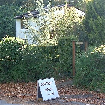 Pottery showroom behind hedge.