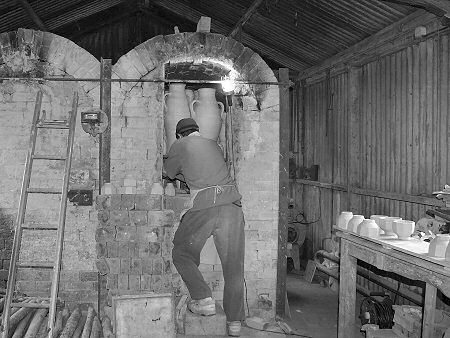 Jeremy Leach packing the kiln at Lowerdown
