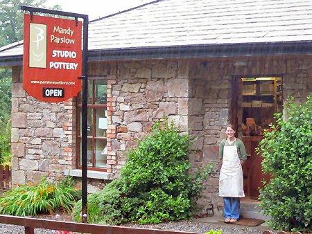 Mandy Parslow outside her pottery in the pouring rain