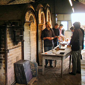 Pots coming out of the kiln, Nick Rees nearest potter