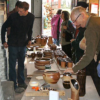 Visitors examining pots straight from the kiln
